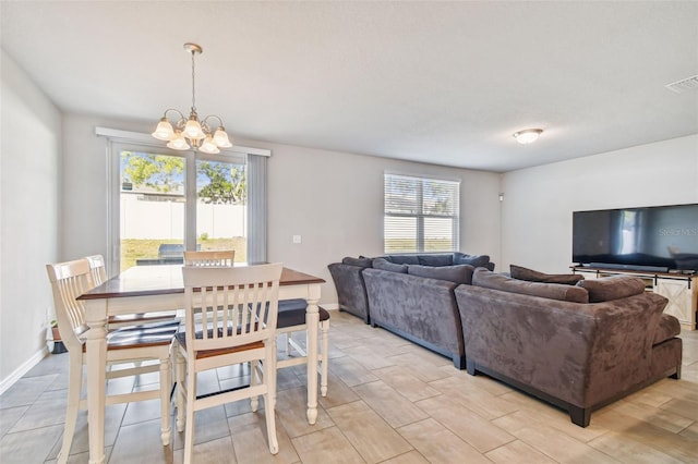 dining area featuring an inviting chandelier and light hardwood / wood-style floors