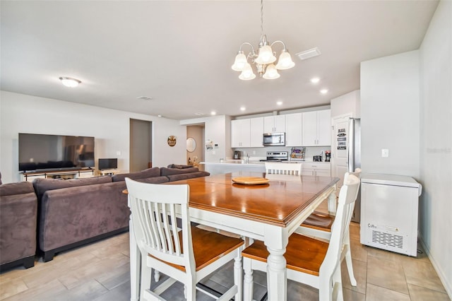 dining space with an inviting chandelier