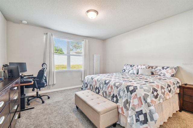 bedroom featuring light carpet and a textured ceiling