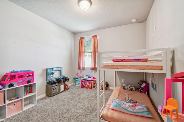 bedroom with carpet and a textured ceiling