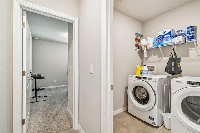 clothes washing area featuring washer and dryer