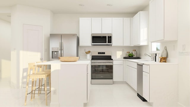 kitchen featuring appliances with stainless steel finishes, sink, white cabinets, and a kitchen bar