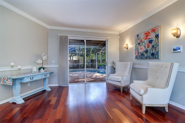 sitting room with ornamental molding and dark hardwood / wood-style floors