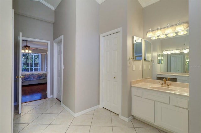 bathroom with tile patterned flooring, vanity, and crown molding