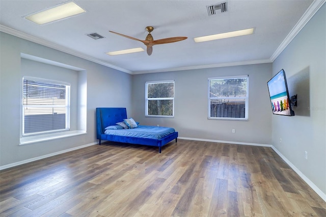 unfurnished bedroom featuring hardwood / wood-style flooring, ornamental molding, and ceiling fan