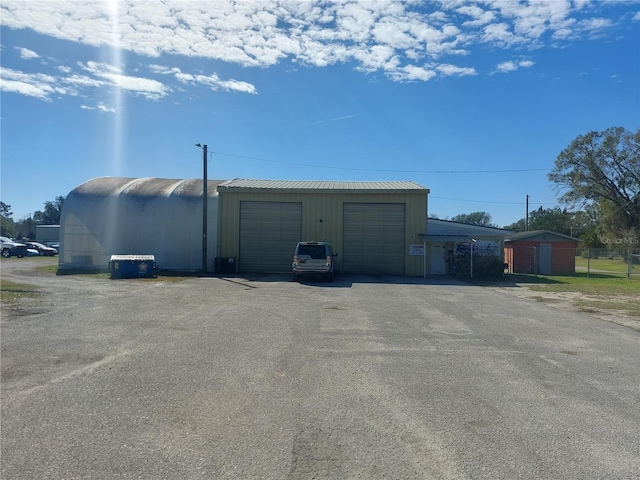 view of outdoor structure featuring a carport and a garage