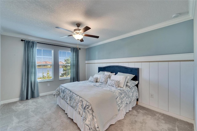 carpeted bedroom featuring ornamental molding, a water view, a textured ceiling, and ceiling fan