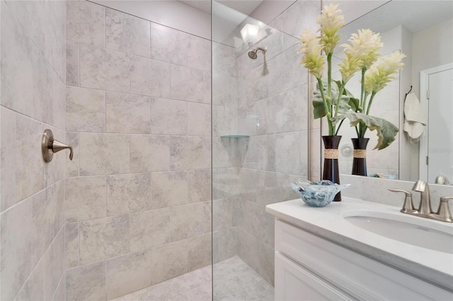 bathroom featuring vanity and tiled shower