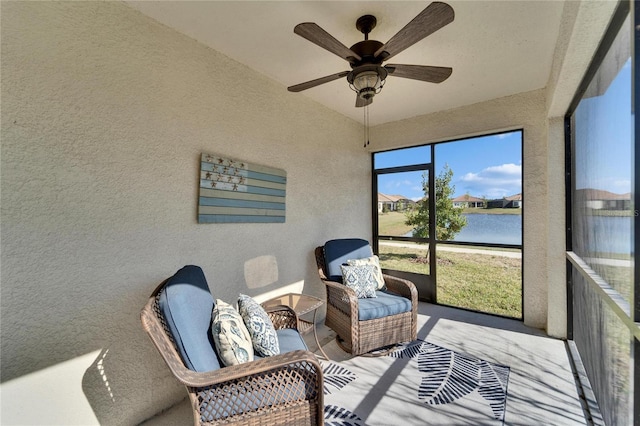 sunroom with ceiling fan, a water view, and vaulted ceiling