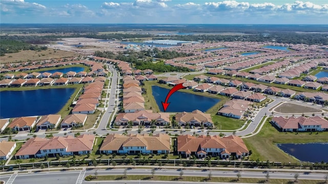 birds eye view of property with a water view