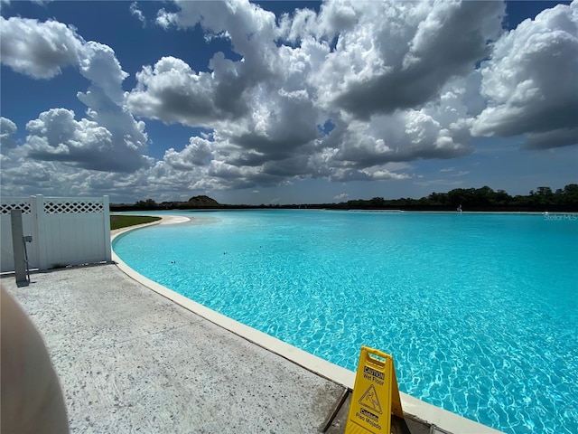 view of pool with a water view