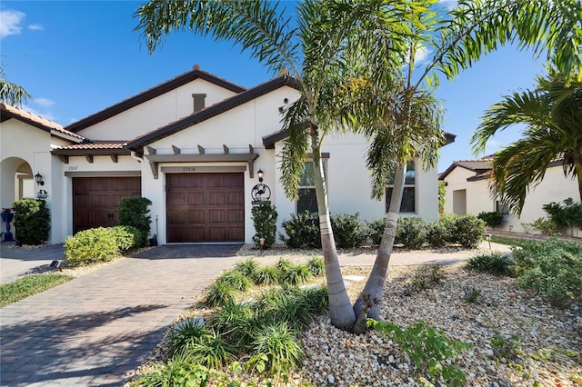 mediterranean / spanish home featuring a garage