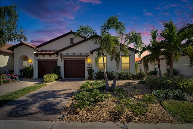 mediterranean / spanish-style home featuring a garage