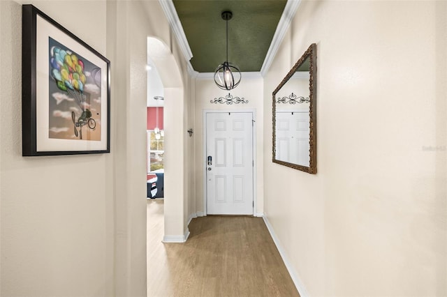 hall with hardwood / wood-style flooring and ornamental molding