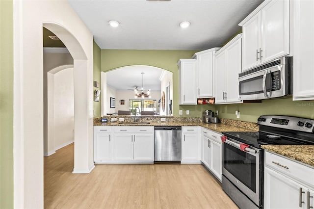 kitchen featuring stainless steel appliances, sink, and white cabinets