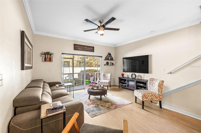 living room with wood-type flooring, ceiling fan, and crown molding