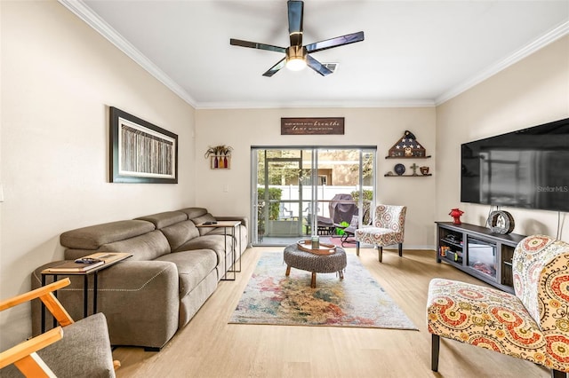 living room with crown molding, ceiling fan, and light hardwood / wood-style floors