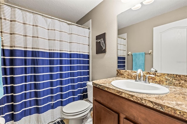 bathroom featuring vanity, toilet, and a textured ceiling