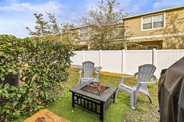 view of yard with a fire pit