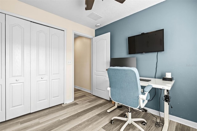 office area with light hardwood / wood-style floors and ceiling fan