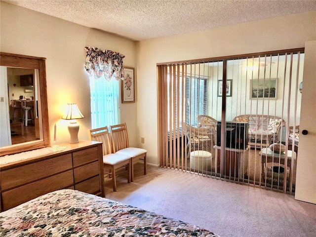 carpeted bedroom featuring a textured ceiling