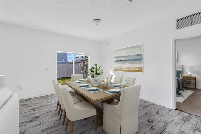 dining area featuring a textured ceiling