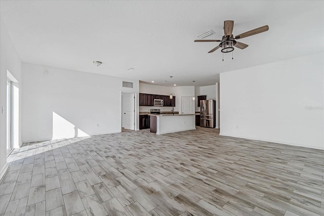 unfurnished living room featuring light wood-type flooring and ceiling fan