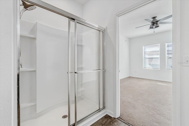 bathroom with an enclosed shower and ceiling fan