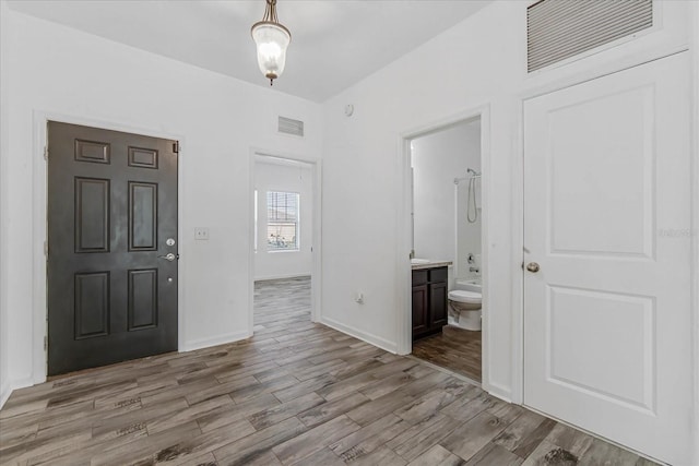 foyer entrance with light hardwood / wood-style floors