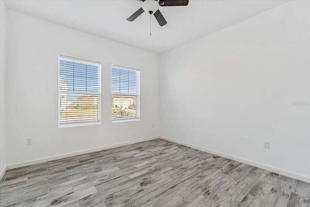 spare room featuring ceiling fan and light hardwood / wood-style flooring