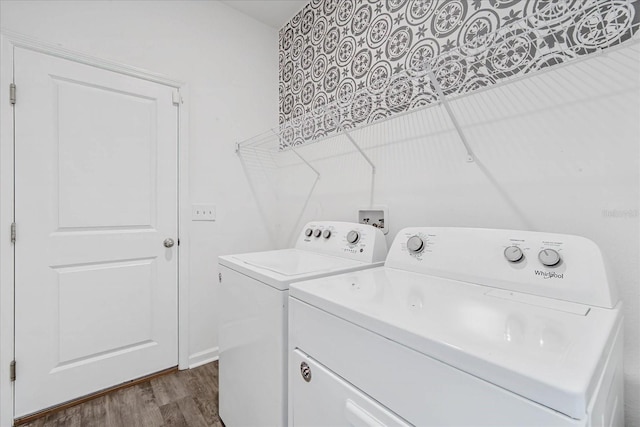 clothes washing area with dark wood-type flooring and washer and dryer