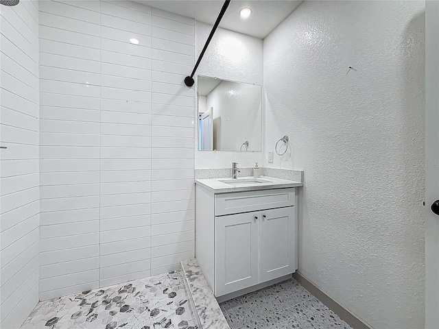 bathroom featuring vanity and a tile shower