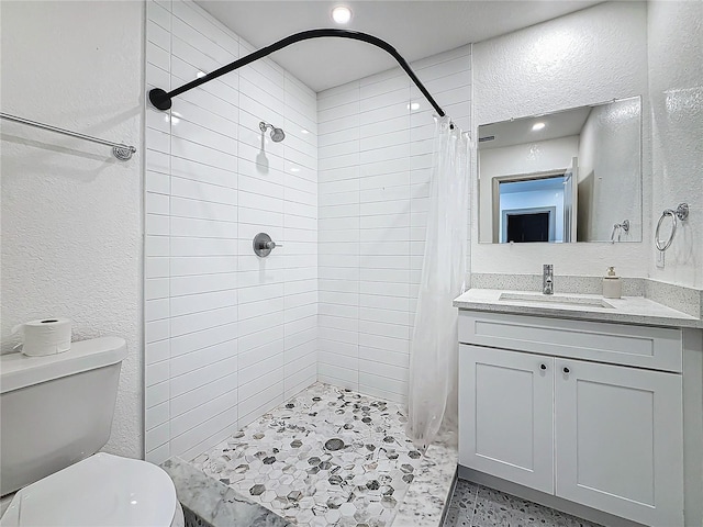 bathroom featuring vanity, curtained shower, and toilet