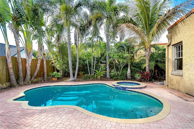 view of pool with an in ground hot tub