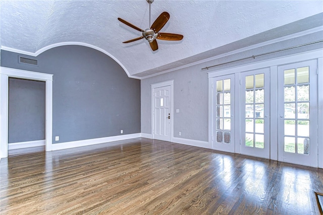 unfurnished living room with lofted ceiling, dark hardwood / wood-style floors, and a textured ceiling