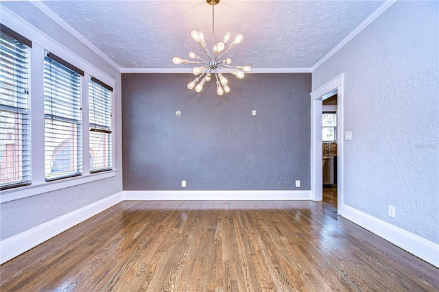 empty room with crown molding, dark hardwood / wood-style flooring, and an inviting chandelier