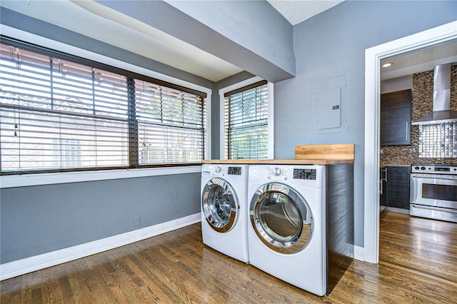 clothes washing area featuring washer and dryer, electric panel, and dark hardwood / wood-style flooring