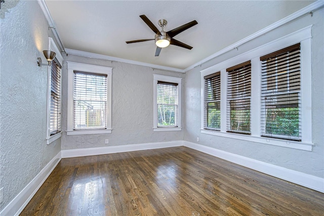 empty room featuring crown molding, ceiling fan, and dark hardwood / wood-style floors