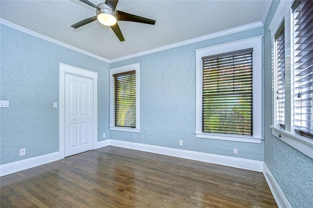 unfurnished room featuring crown molding, a textured ceiling, dark hardwood / wood-style floors, and ceiling fan