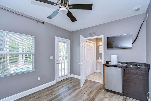 interior space featuring light hardwood / wood-style floors, stainless steel refrigerator, and ceiling fan