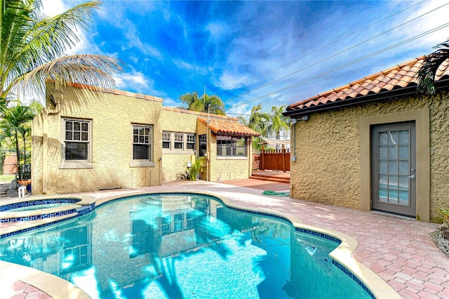 view of pool with an in ground hot tub and a patio