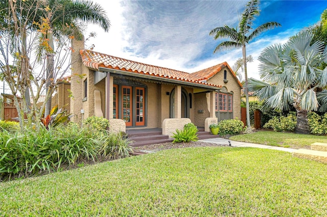 mediterranean / spanish house with a front lawn