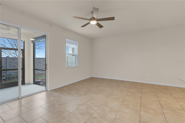 tiled empty room featuring ceiling fan