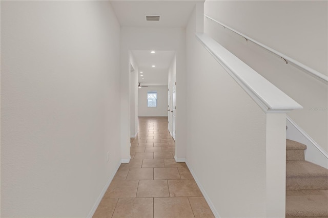 hall with light tile patterned floors