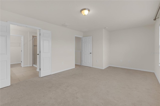 unfurnished room with light colored carpet