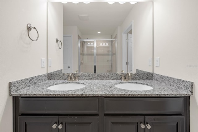 bathroom with vanity and a shower with door