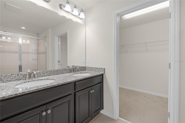 bathroom featuring vanity and an enclosed shower