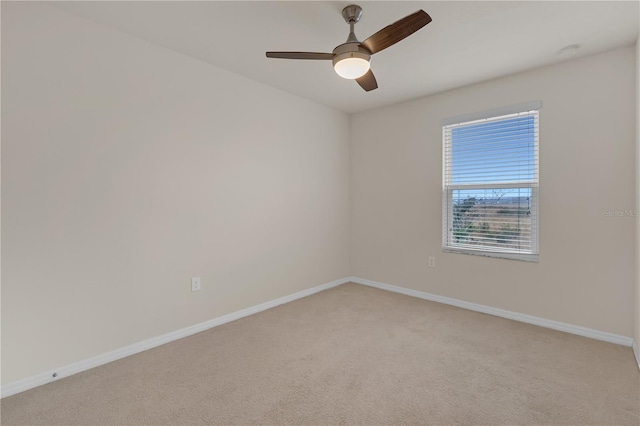 spare room with ceiling fan and light carpet