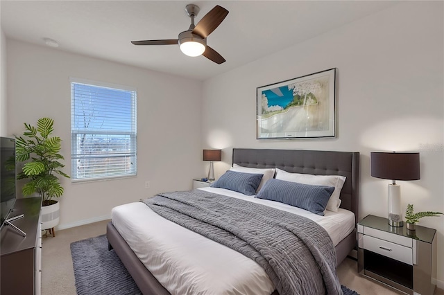 bedroom with ceiling fan and light colored carpet