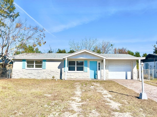 ranch-style house with a garage and a front yard